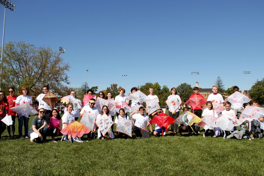 Students holding homemade kites